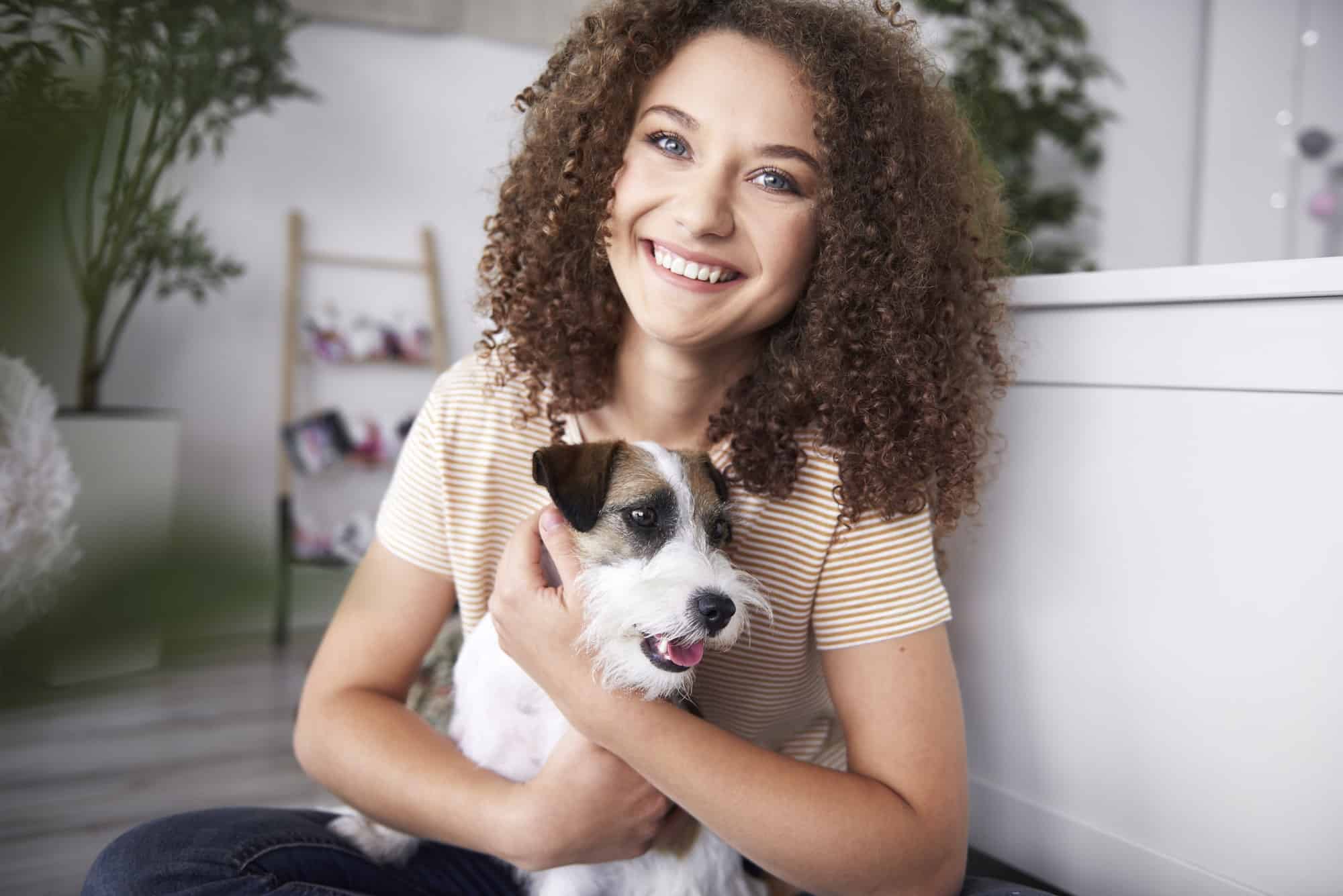 portrait-of-smiling-teenage-girl-with-her-dog